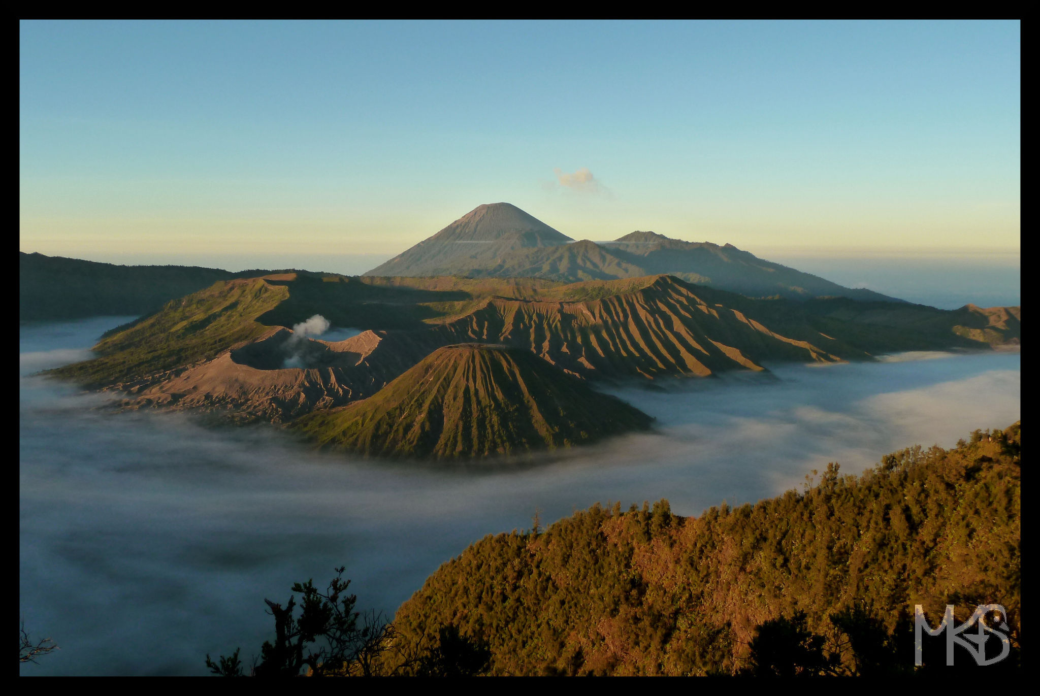 Panoramic view of Mt. Bromo (the steaming crater), Mt. Batok, Mt. Semeru (the highest).